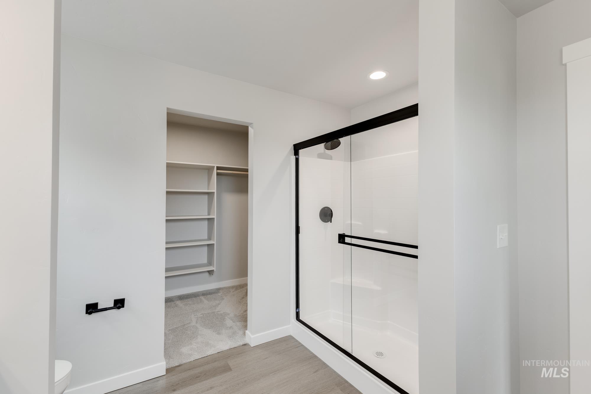 3672 West Dover Drive Meridian, ID 83642 - Photo 21 of 23 Bathroom with a walk in closet, a stall shower, light wood-style floors, and recessed lighting