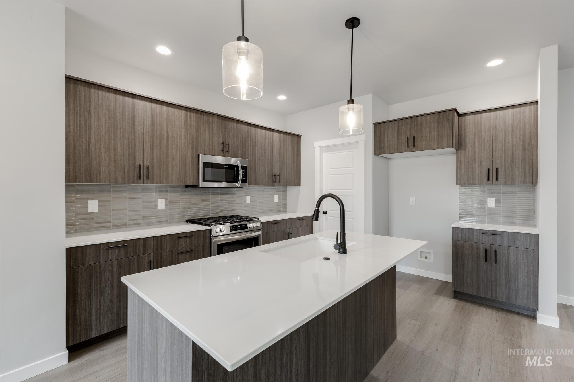 3672 West Dover Drive Meridian, ID 83642 - Photo 4 of 23 Kitchen featuring decorative backsplash, modern cabinets, decorative light fixtures, stainless steel appliances, and recessed lighting