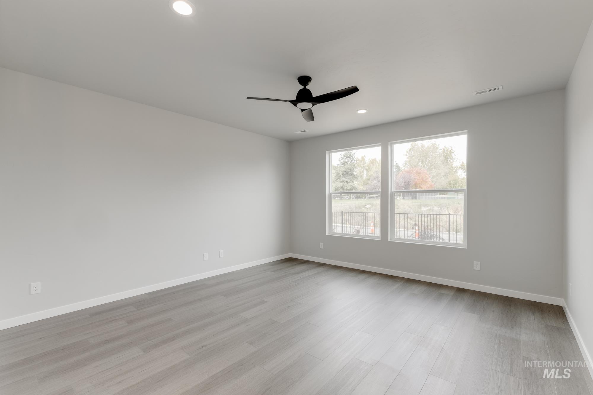 3672 West Dover Drive Meridian, ID 83642 - Photo 7 of 23 Unfurnished room featuring light wood-style floors, a ceiling fan, and recessed lighting