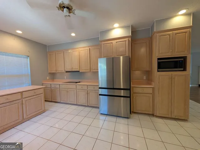 a kitchen with cabinets and stainless steel appliances