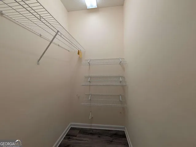 a view of storage and utility room with racks on the wall