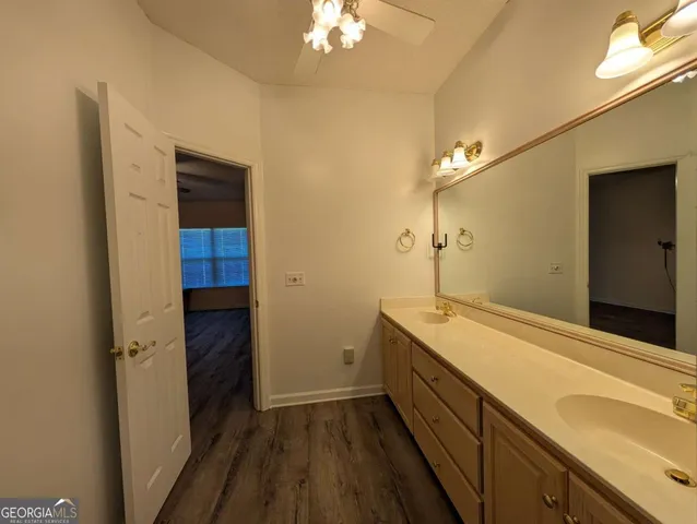 a spacious bathroom with a sink and a mirror