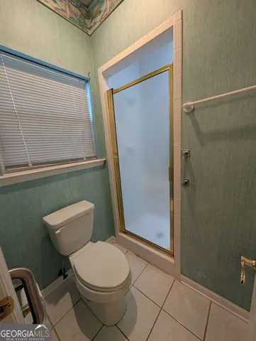 a bathroom with a toilet a sink and shower