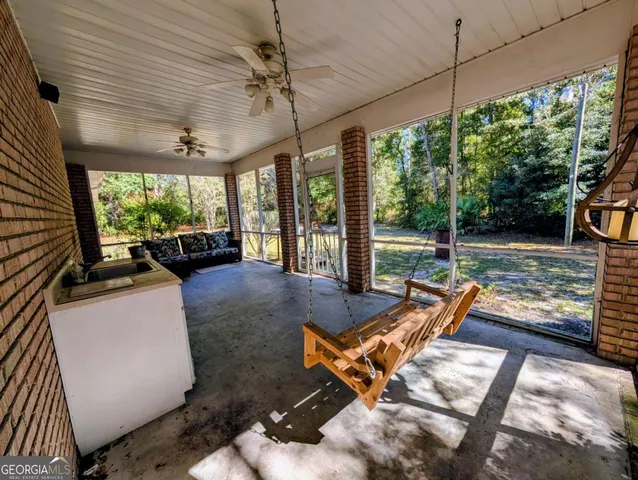 a view of a patio with a table chairs and a backyard