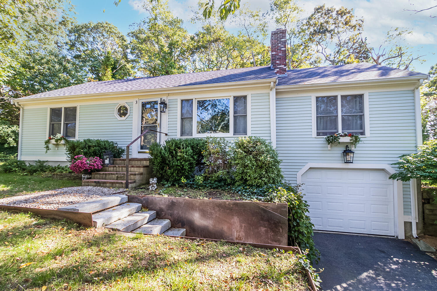 a front view of house with yard and outdoor seating