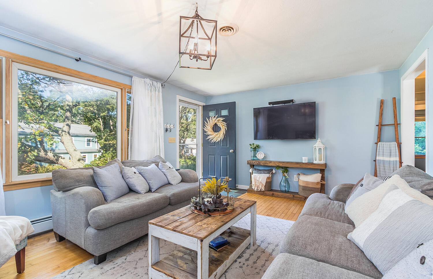3 Nickerson Road Harwich, MA 02645 - Photo 11 of 23 a living room with furniture a flat screen tv and a large window
