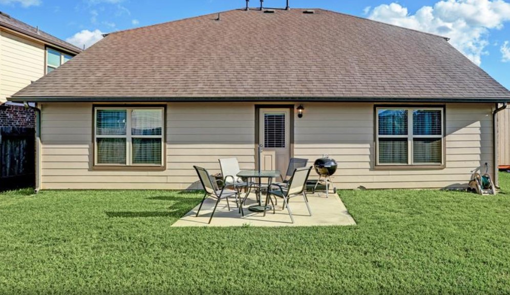 1 Rodeo Bend Drive Manvel, TX 77578 - Photo 16 of 22 a backyard of a house with table and chairs