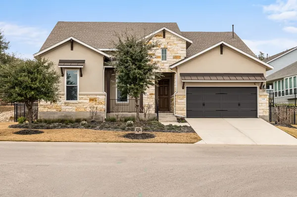 a front view of a house with a yard and garage