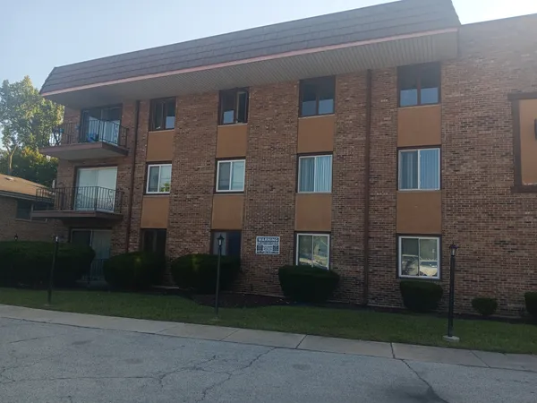 a brick building with a yard in front of it