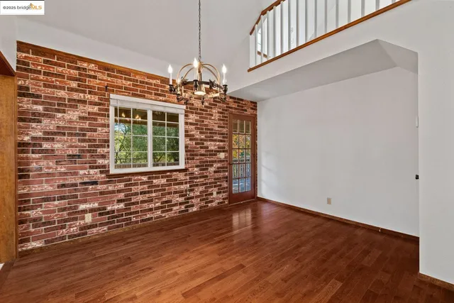 a view of staircase with wooden floor and white walls