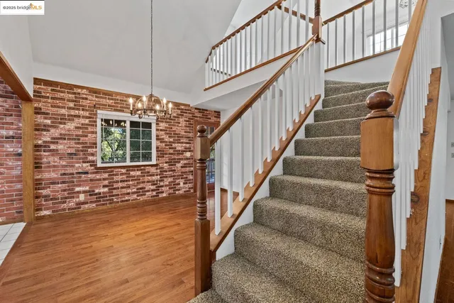 a living room with furniture fireplace and a large window
