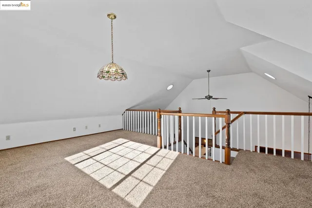 a view of a hallway with windows and stairs