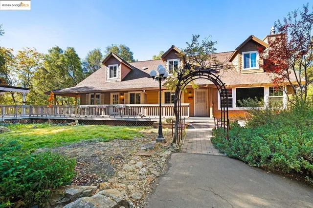 a front view of a house with yard and green space