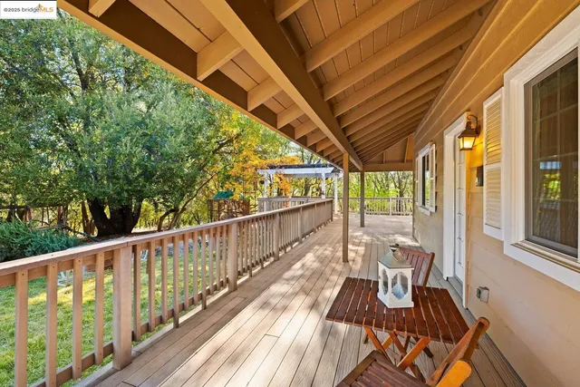 a view of balcony with wooden floor and fence