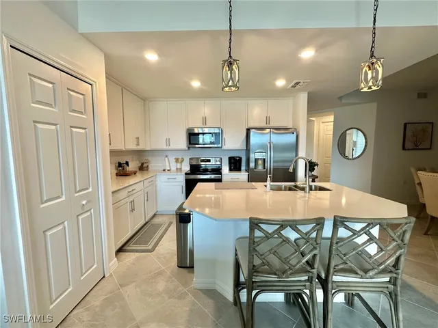 a large kitchen with a table and chairs