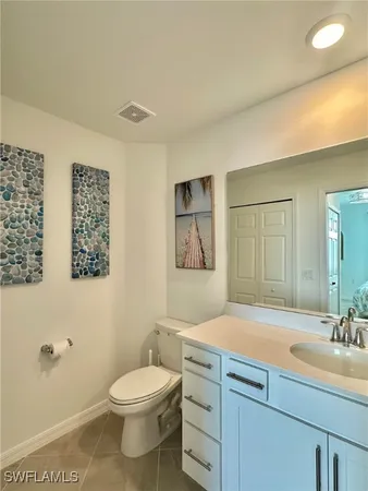 a bathroom with a sink a toilet and mirror