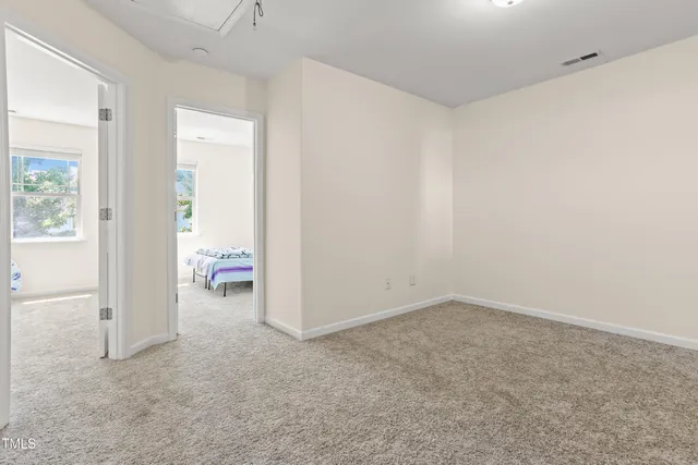 a spacious bedroom with a bed and window