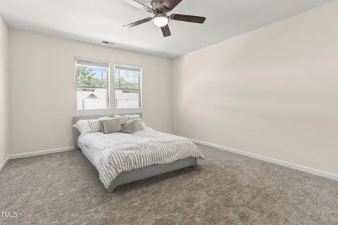 a bed sitting in a bedroom next to a window