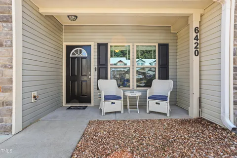 a view of an outdoor space with porch and wooden floor