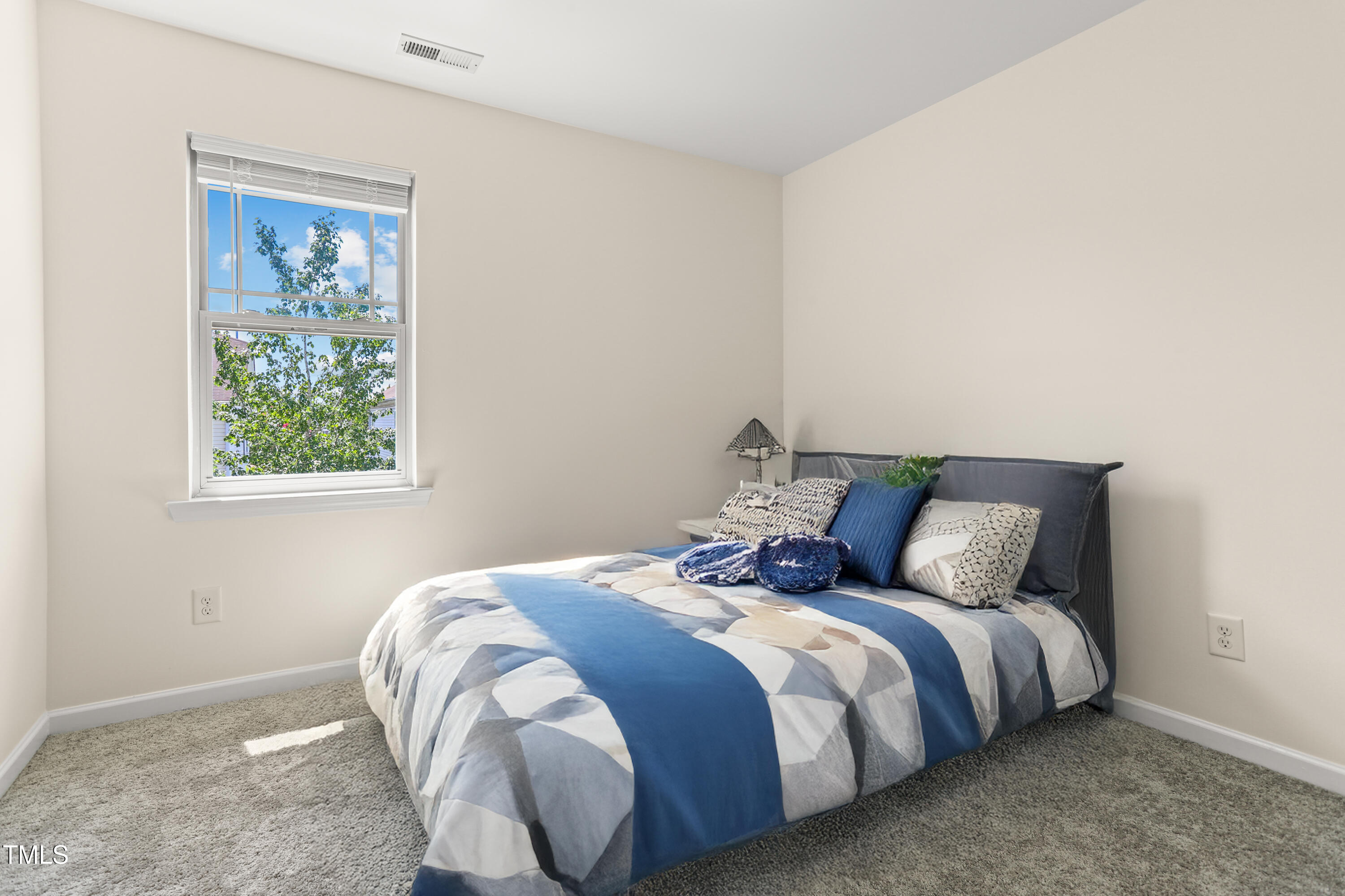 6420 Hatchies Drive Raleigh, NC 27610 - Photo 21 of 24 a bed sitting in a bedroom next to a window