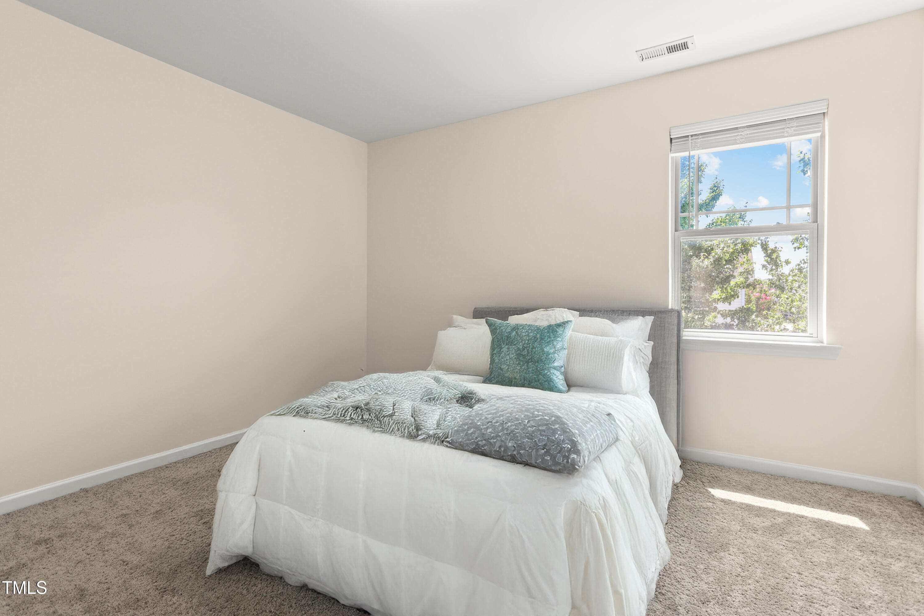 6420 Hatchies Drive Raleigh, NC 27610 - Photo 22 of 24 a large bed sitting in a bedroom next to a window