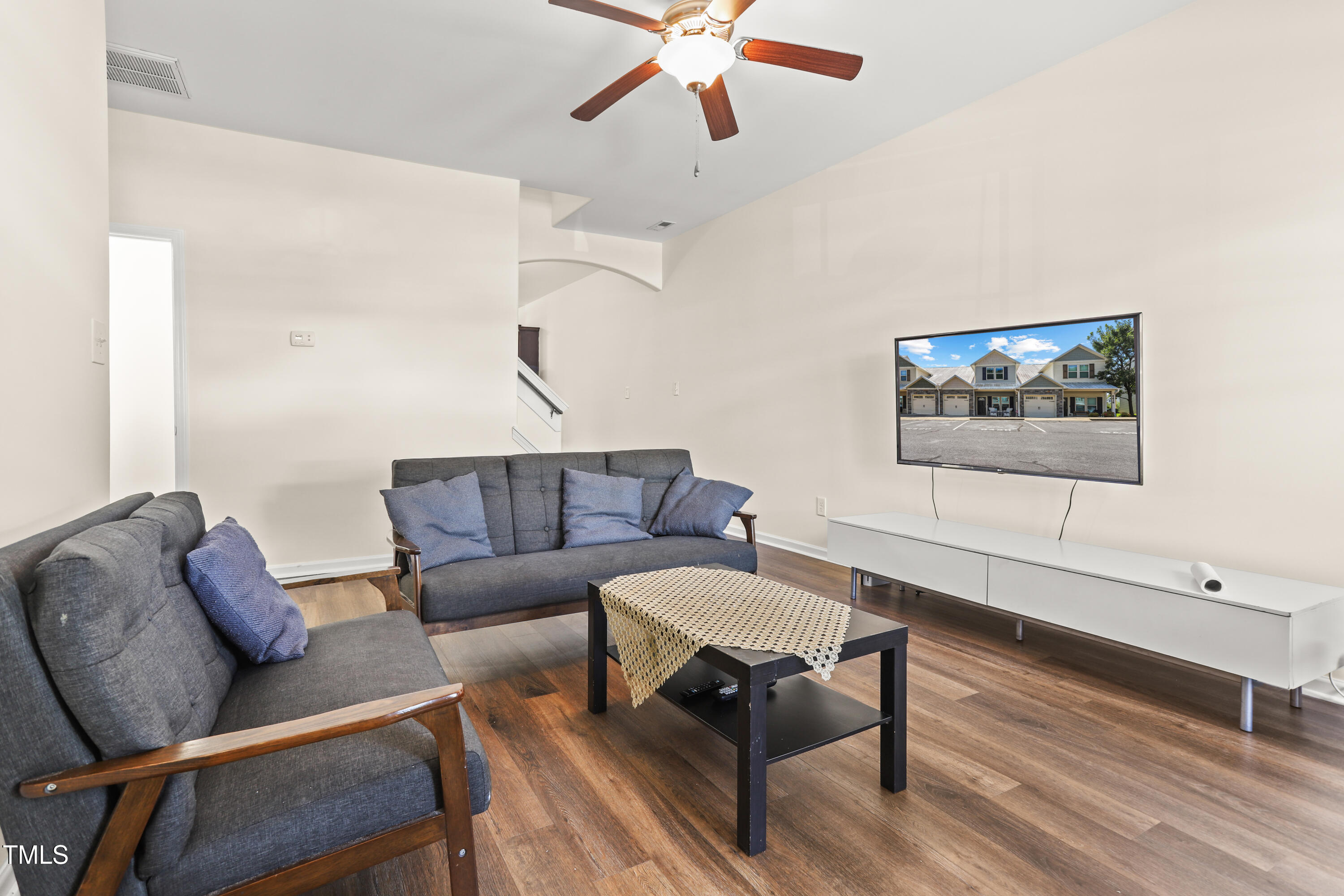 6420 Hatchies Drive Raleigh, NC 27610 - Photo 3 of 24 a living room with furniture a rug and a ceiling fan