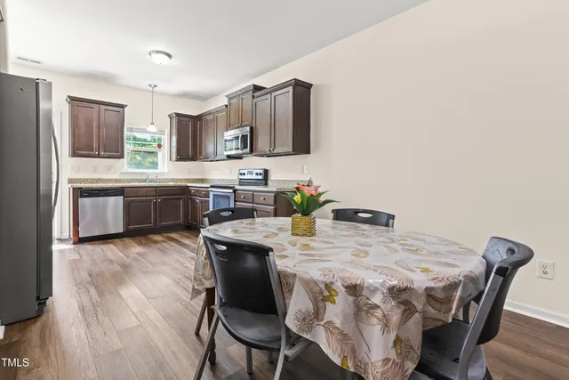 a view of a dining room with furniture and wooden floor