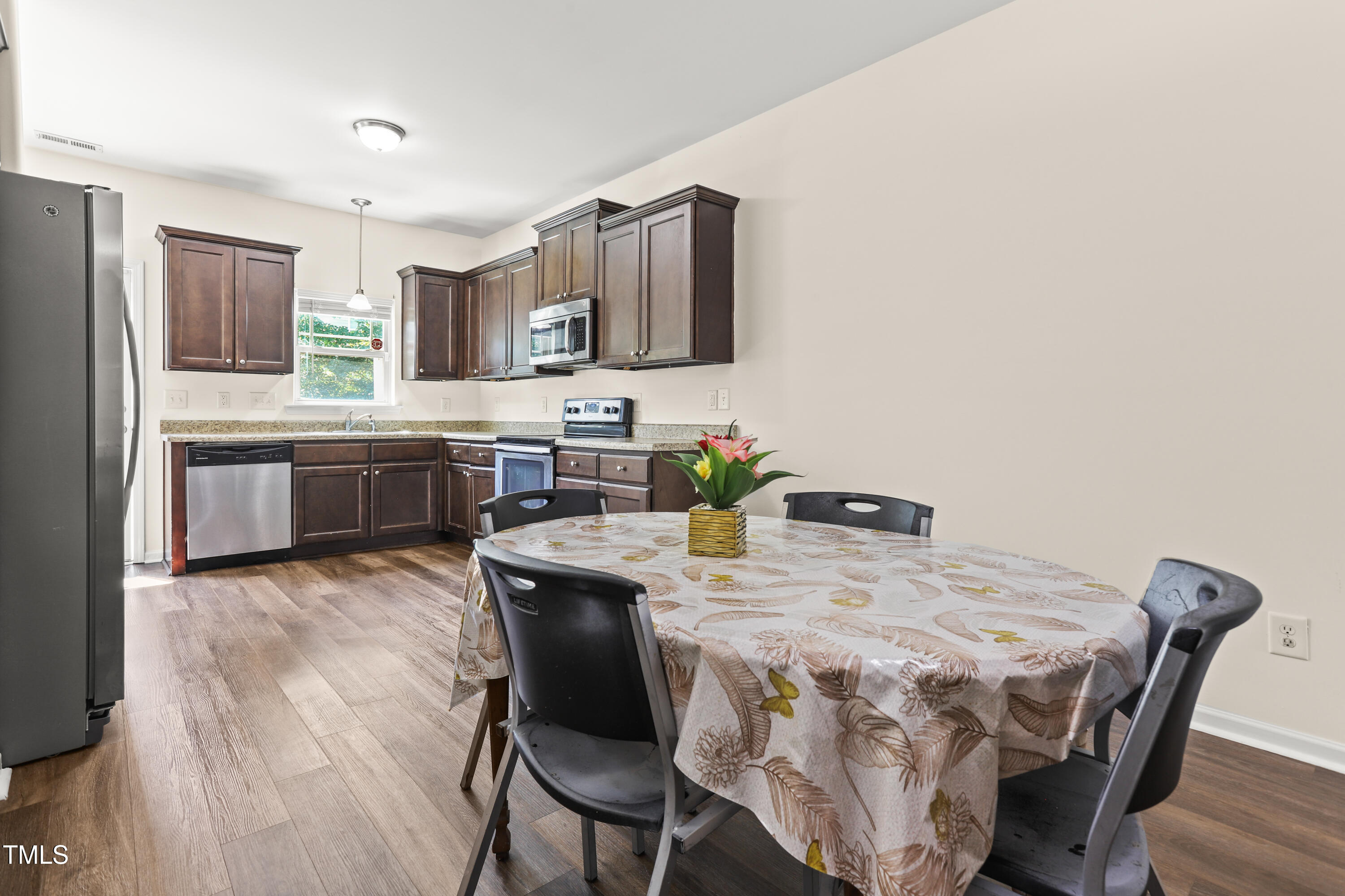 6420 Hatchies Drive Raleigh, NC 27610 - Photo 7 of 24 a view of a dining room with furniture and wooden floor