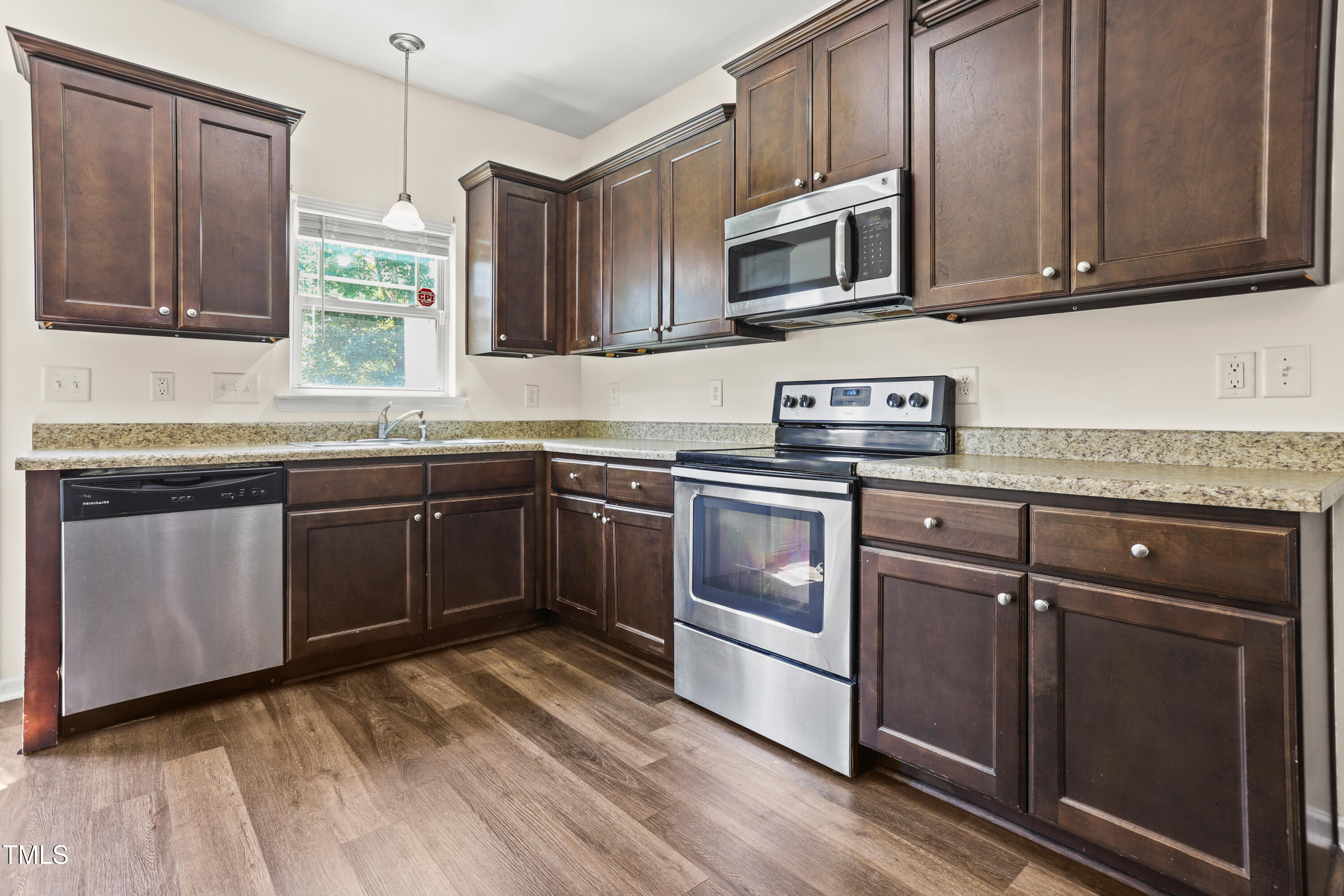 6420 Hatchies Drive Raleigh, NC 27610 - Photo 8 of 24 a kitchen with stainless steel appliances granite countertop a sink stove and microwave