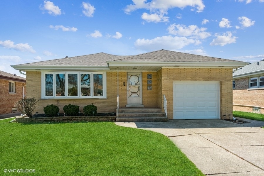 7045 West Madison Street Niles, IL 60714 - Photo 1 of 22 a front view of a house with a garden