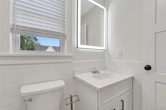 a view of a room with wooden floor and a window
