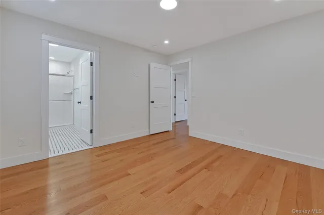 a view of a room with wooden floor