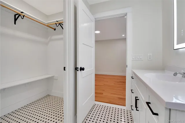 a bathroom with a sink a toilet a mirror and shower