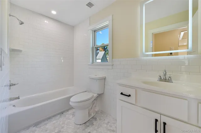 a bathroom with a sink a toilet and a bathtub