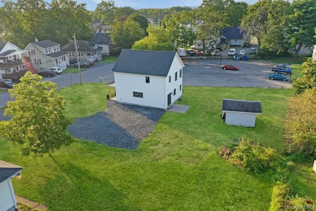 an aerial view of a house with outdoor space