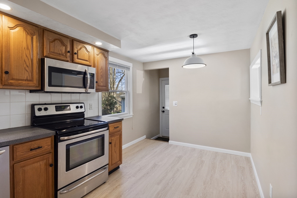 165 Sawmill Road Springfield, MA 01118 - Photo 22 of 39 a kitchen with stainless steel appliances a stove microwave and refrigerator