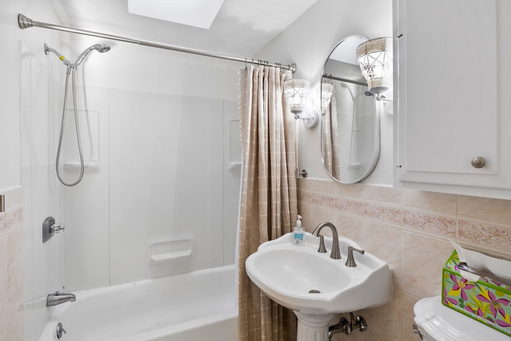 165 Sawmill Road Springfield, MA 01118 - Photo 27 of 39 a bathroom with a sink a mirror and a shower