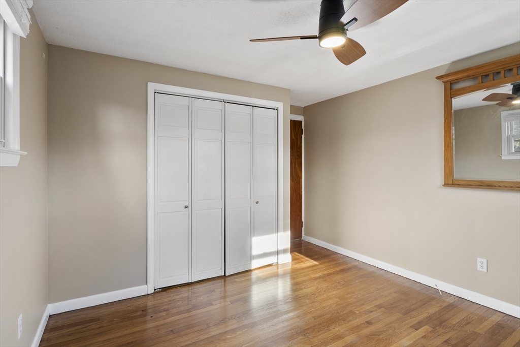 165 Sawmill Road Springfield, MA 01118 - Photo 31 of 39 an empty room with wooden floor cabinet and windows