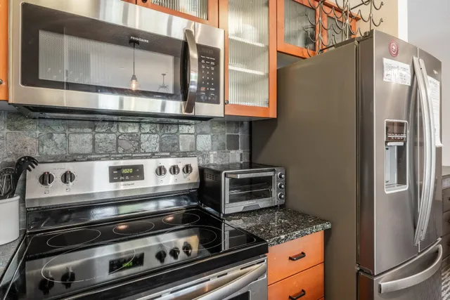 a close view of a stove top oven and refrigerator