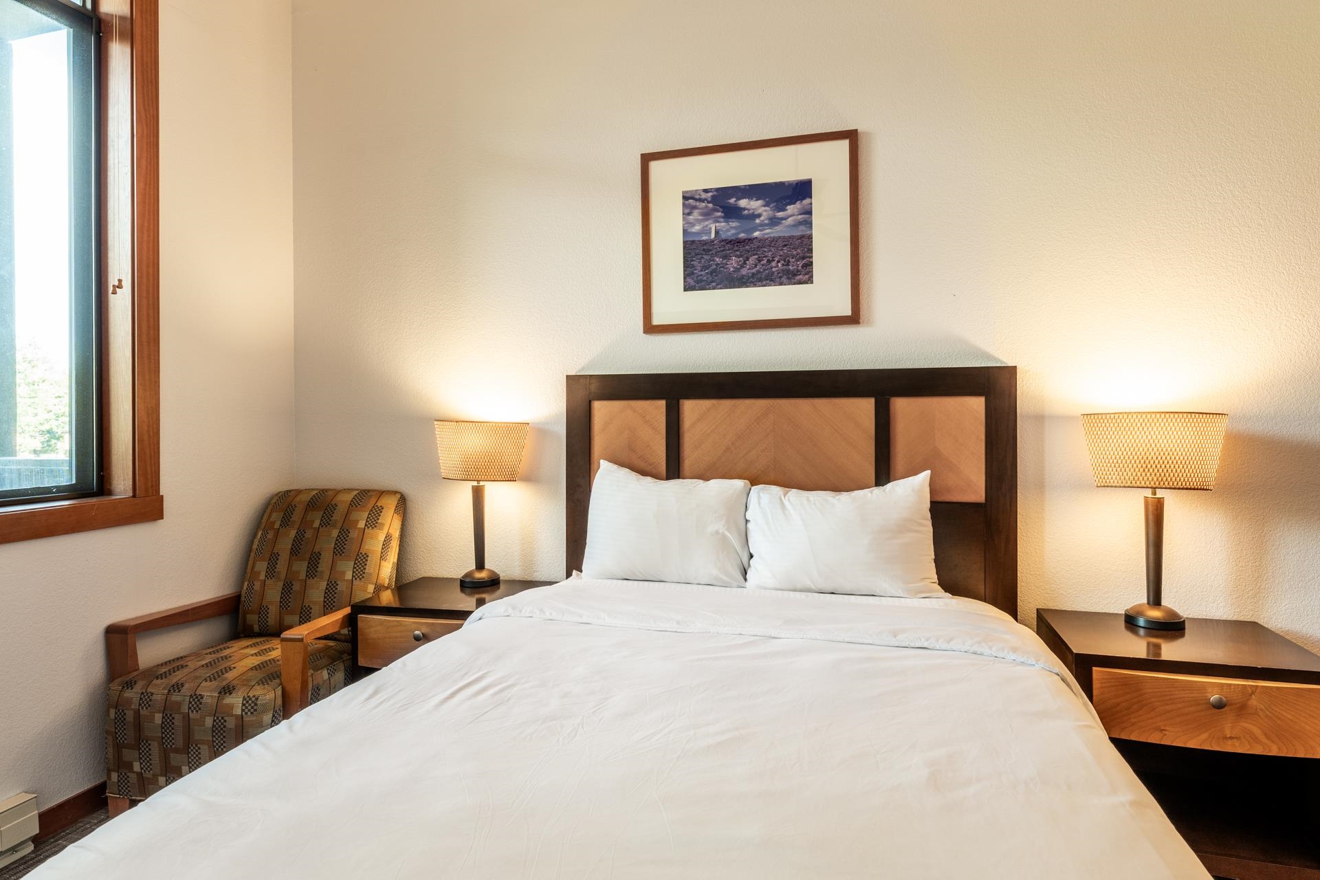 6201 Minaret Road, Unit 2117 Mammoth Lakes, CA 93546 - Photo 24 of 47 a bedroom with a bed and a chair with painting on the wall