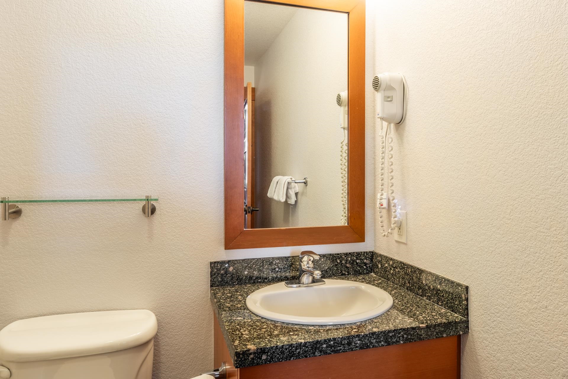 6201 Minaret Road, Unit 2117 Mammoth Lakes, CA 93546 - Photo 25 of 47 a bathroom with a granite countertop sink and a mirror