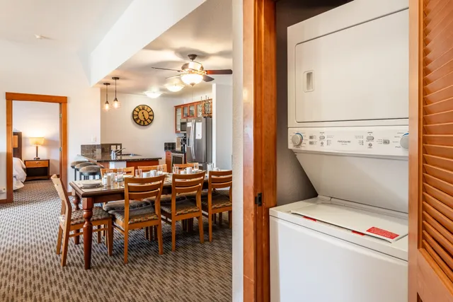 a dining room with a wooden table and chairs