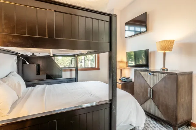 a bedroom with a bed window and flowerpot