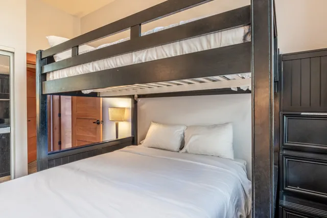 a bedroom with a bed and a large window