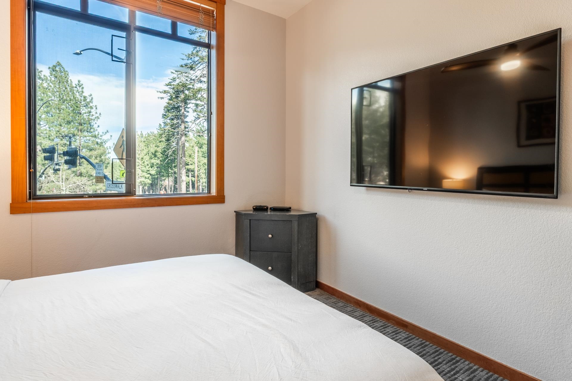 6201 Minaret Road, Unit 2117 Mammoth Lakes, CA 93546 - Photo 36 of 47 a bedroom with a bed and a flat tv screen on dresser