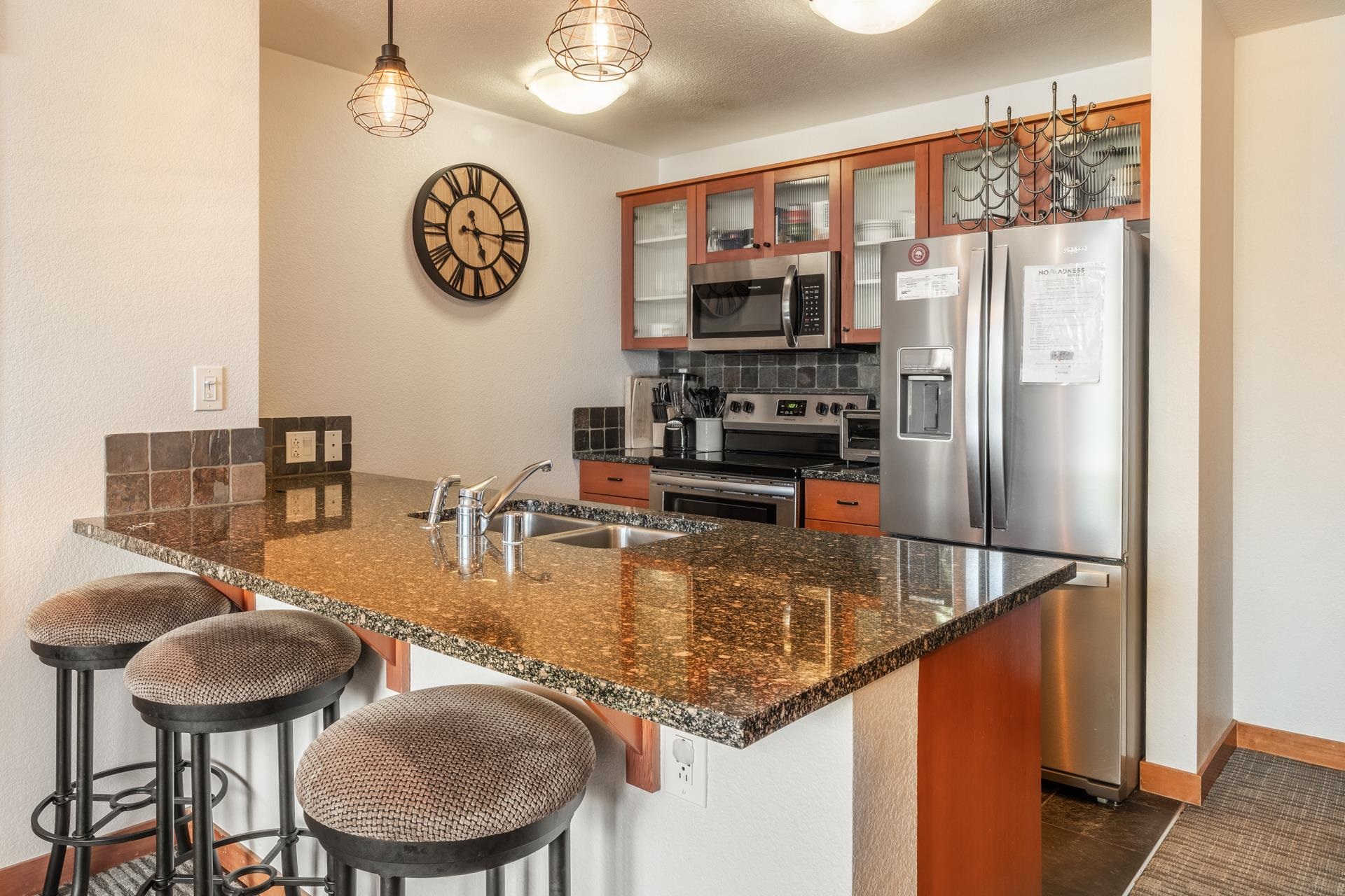 6201 Minaret Road, Unit 2117 Mammoth Lakes, CA 93546 - Photo 5 of 47 a kitchen with stainless steel appliances granite countertop a sink and a refrigerator
