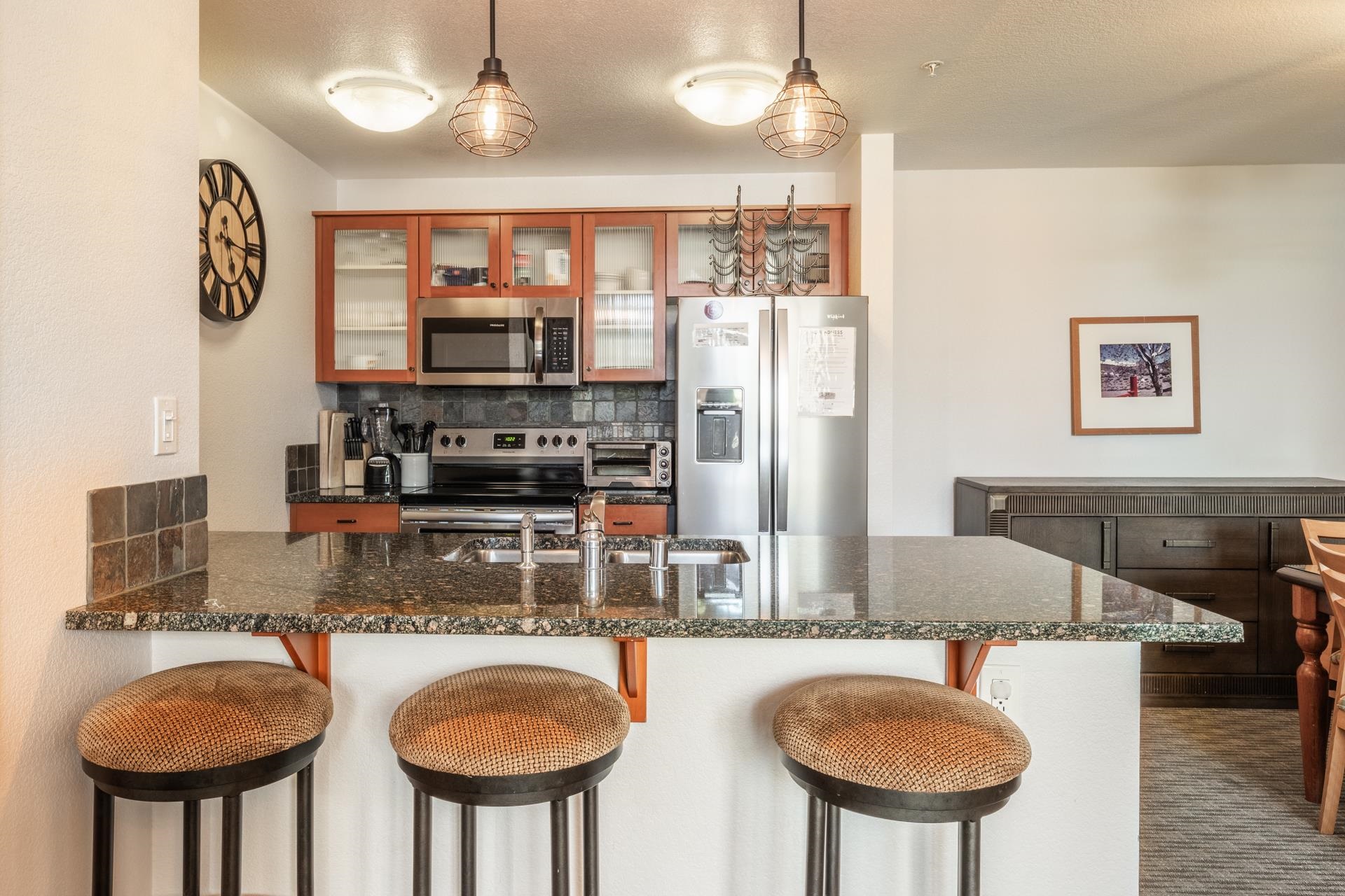 6201 Minaret Road, Unit 2117 Mammoth Lakes, CA 93546 - Photo 9 of 47 a kitchen with stainless steel appliances granite countertop a sink a stove and a refrigerator
