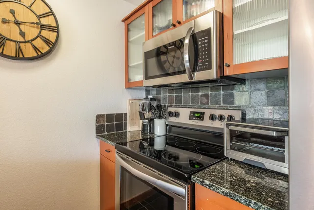 a kitchen with a stove and a microwave