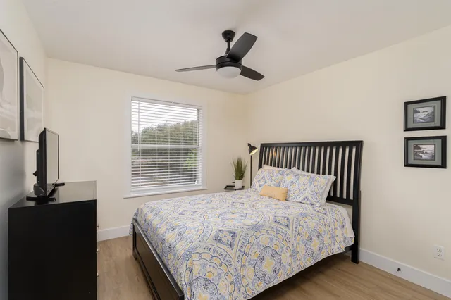 a bedroom with a bed and a window