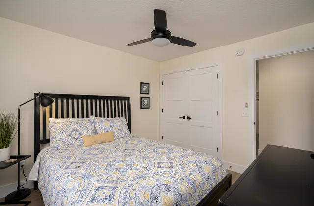a bedroom with a bed and a chandelier